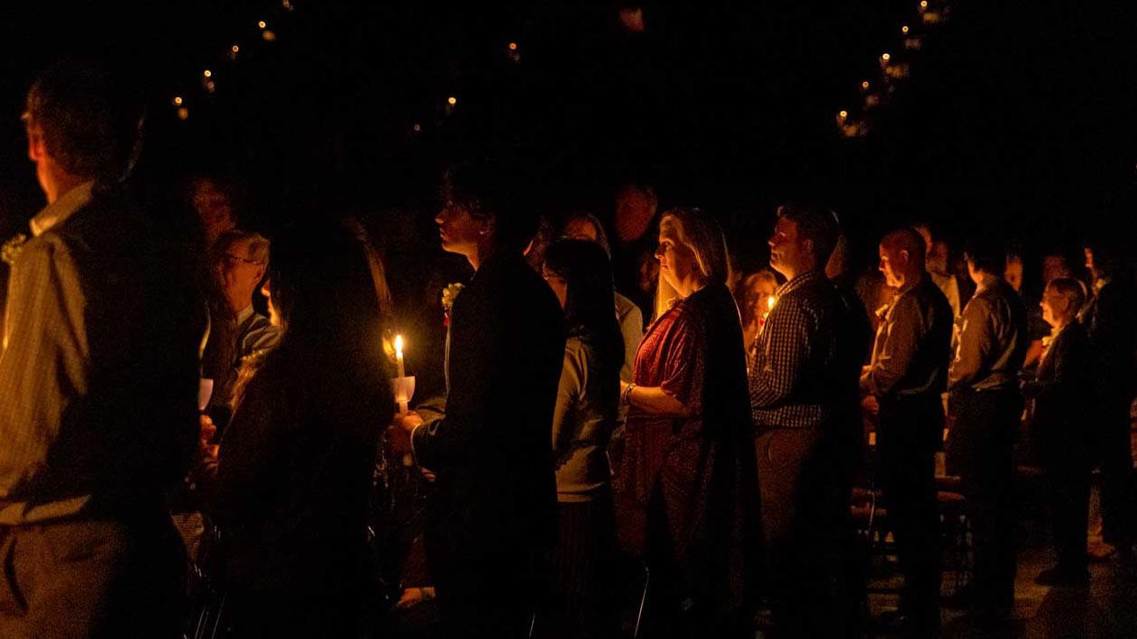 Solemn Muster photo with attendees holding candles